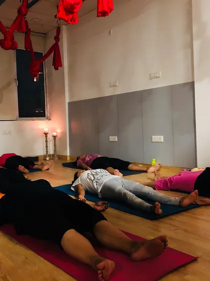 Participants resting in Savasana (corpse pose) after a deep meditation. This is a crucial part of the practice, allowing the body and mind to absorb the benefits of the session.