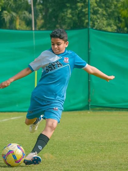 A player executes a clean strike on the ball, demonstrating proper form and technique during a match.