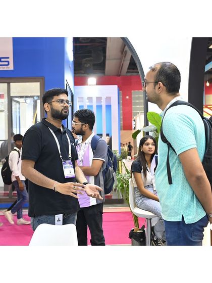 A member of our team in a detailed discussion during the first day of the exhibition. We love sharing our ideas and showcasing our latest innovations with everyone who visits.