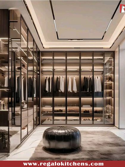 For a bold and sophisticated look, we used dark framing and glass doors in this walk-in closet. The integrated LED lighting highlights the clothing and accessories, creating a dramatic and organized display.
