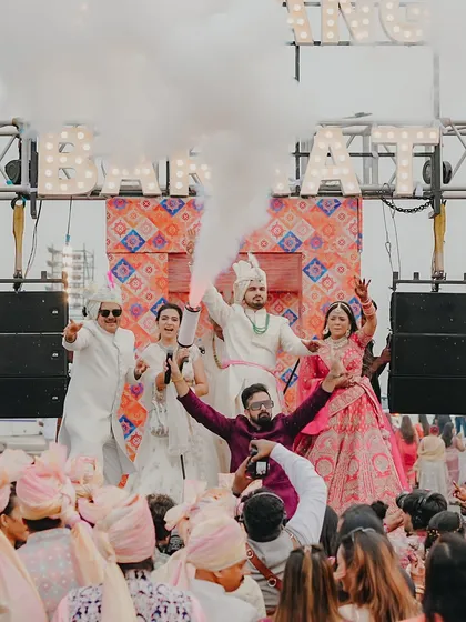 An epic shot with the entire wedding party on the baraat truck, surrounded by smoke and cheers. I am right there in the middle, fueling the excitement.