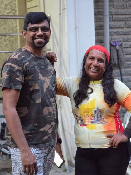 A candid moment between two riders at the end of the Rajyotsava 200K, sharing a smile of accomplishment.