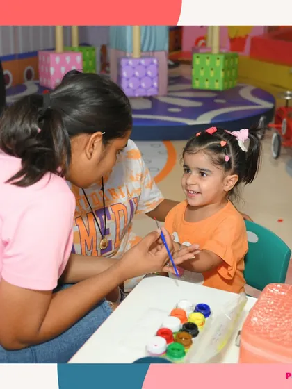 A close-up of a hand painting session. This little girl is all smiles as she gets her design.