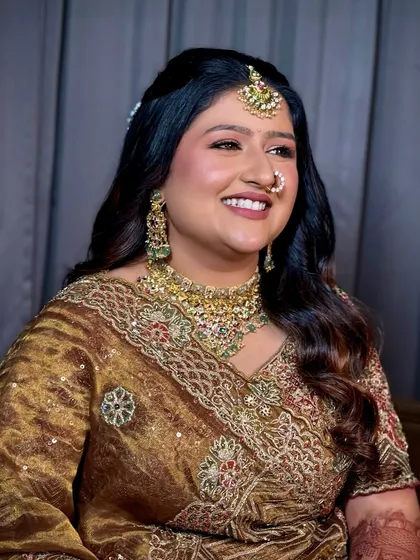 A beautiful, smiling portrait. I used warm, earthy tones for her makeup to complement the unique color of her bridal outfit.