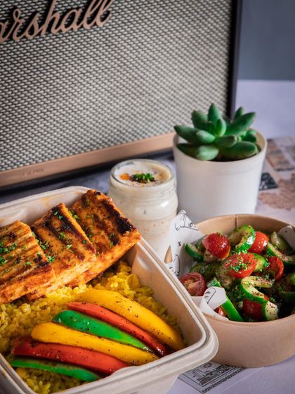 Our Shish Tawook meal, packed and ready for delivery with a side salad and dip. It's the perfect summer meal.