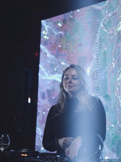 A moment of calm before the storm, standing in front of a cosmic visual display before my set begins.