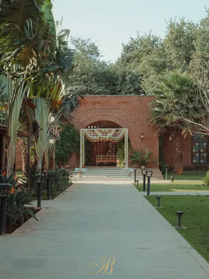 A distant view showing how the entrance arch creates a grand welcome, leading guests down a path to the main event area.