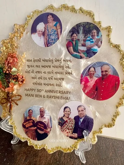 A beautiful 50th-anniversary gift, this frame includes multiple family photos, a message in Gujarati, and a preserved flower bouquet.