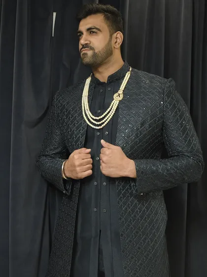 Another angle of our popular black Indo-western set, showing how the jacket can be worn with a stole for added drama.