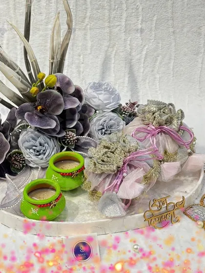 My Diwali Edit is live! This hamper, in shades of purple and green, features hand-painted 'diyas', elegant dry fruit 'potlis', and floral-themed 't-light' holders.