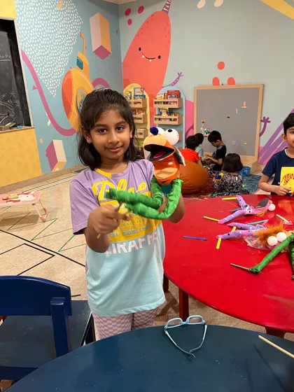 Another happy camper with her finished puppet. It's so rewarding to see the pride on their faces after they've created something with their own hands.