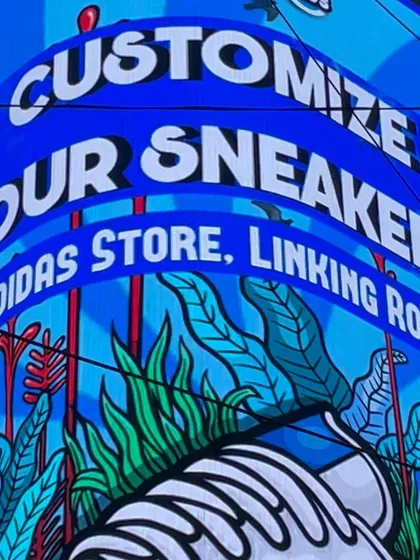 A close-up of the vibrant branding at our "Customize Your Sneakers" event with Adidas. The setup is designed to be as eye-catching as the art itself.