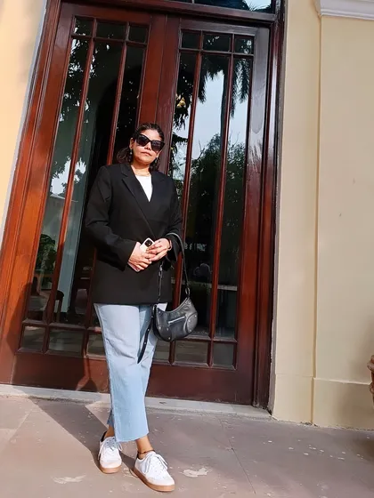 Here is the same minimal outfit with a black blazer and jeans, shot in a different light. It shows how a simple, well-put-together look can be your reliable choice for looking cool and confident.