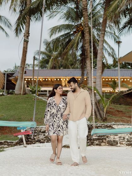 The couple walking through a beach resort, a perfect candid moment.