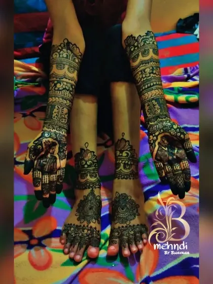 This photo shows a full set of hand and feet mehndi with portrait work on the palms and simpler, matching patterns on the feet.