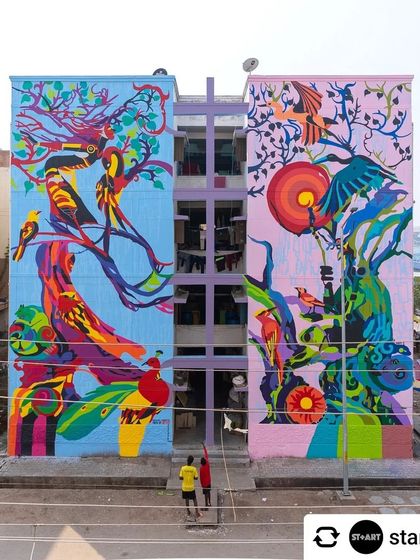 A full view of our mural for the St+art Kovai festival in collaboration with Asian Paints. The contrasting color palettes on the two building faces create a dynamic dialogue about ecology and our connection to the natural world.