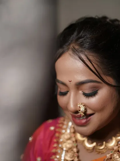 A close-up of bride Shraddha, focusing on her soft eye makeup and traditional nath.