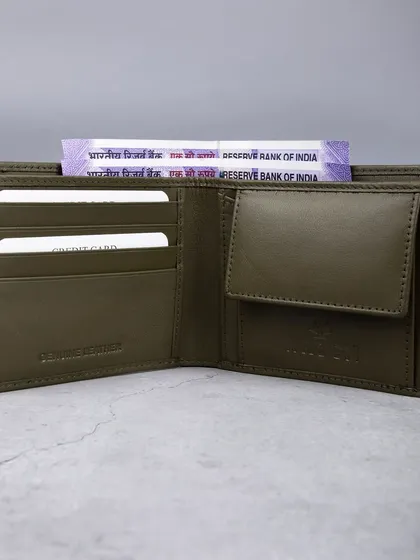 An open view of an olive green wallet, showing its coin pouch and card slots.