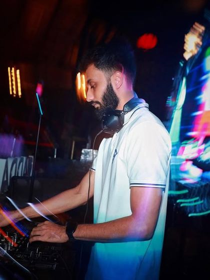 A cool long-exposure shot capturing the movement and energy at the DJ console.