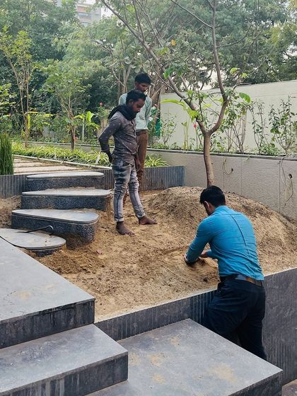 My team at work, carefully shaping the mound and preparing the soil for planting. This hands-on approach ensures that every detail of the design is executed with precision and care.