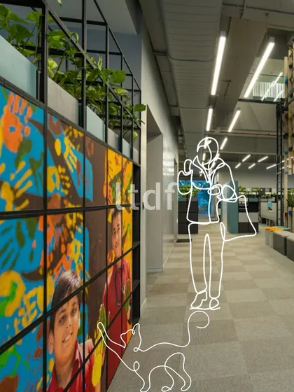 We believe good design shapes the in-between spaces. This office corridor is transformed from a simple passage into a place of belonging, with a vibrant, colorful mural that tells a story and turns a moment of transit into a moment of pause and noticing.