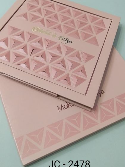 This unique invitation features a 3D geometric pattern on the cover in a soft pink hue. It's a bold and modern design for a couple looking for something different.