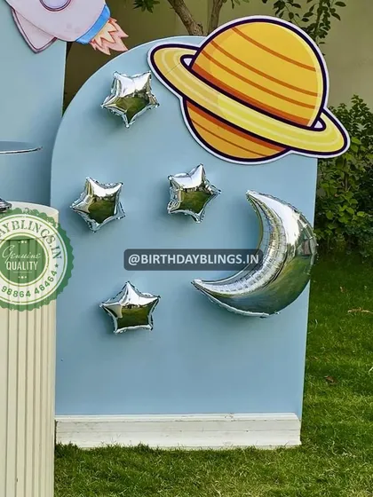 A detail shot of the space party, showing the planet and star cutouts on the backdrop.