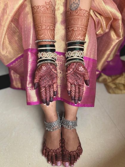 A beautiful shot of the bride's hands and feet, showing how the mehendi creates a complete and cohesive bridal look.