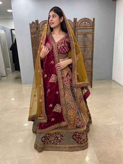 The side view of this velvet bridal lehenga highlights the rich colors and the detailed panel work on the skirt. A perfect example of the unique finds in my collection.