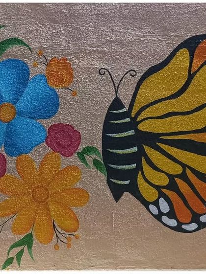 A beautiful mural of a monarch butterfly approaching a bouquet of colourful flowers, perfect for adding a touch of nature's elegance to a room.