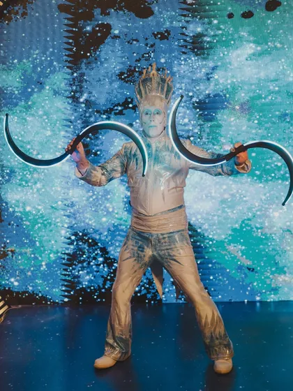 A performer in a futuristic, ice-king costume, part of the atmospheric entertainment that brought the 'Interstellar' theme to life.