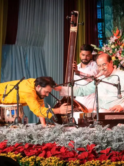 A gallery of cherished moments accompanying the legendary vocalist, Guruji Padma Bhushan Pandit Ajoy Chakraborty ji, at various prestigious festivals.