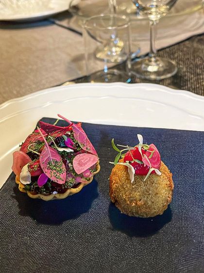 Another view of the beet tartlet and duck croquette, presented on a simple blue napkin to make the colors pop.