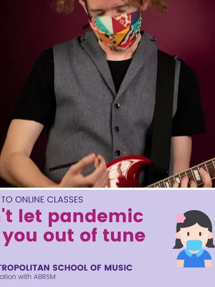 A student wearing a mask plays an electric guitar, illustrating our commitment to safe in-person learning. Our hybrid model allows for seamless continuation of lessons online when needed.