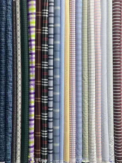 It all starts with the fabric. Here is a small part of my extensive collection of pure cotton shirt materials, featuring a variety of checks, stripes, and prints for you to choose from.