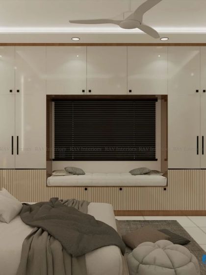 A bedroom design that maximizes storage with a full wall of wardrobes, including a cozy window seat built into the unit.