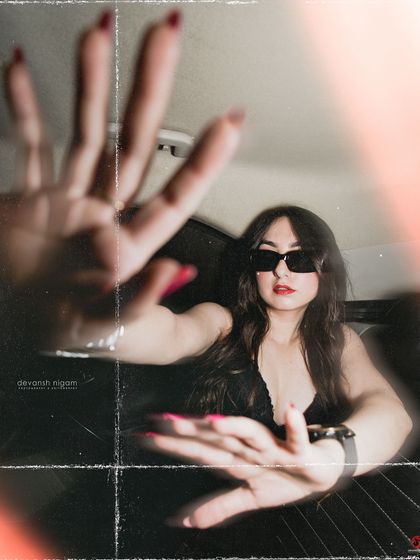 An artistic shot playing with perspective and hand gestures, creating a sense of being caught by the camera.