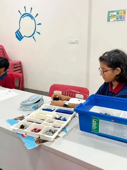 A student at our Vidyashilp Academy after-school program works independently, focused on her LEGO build.