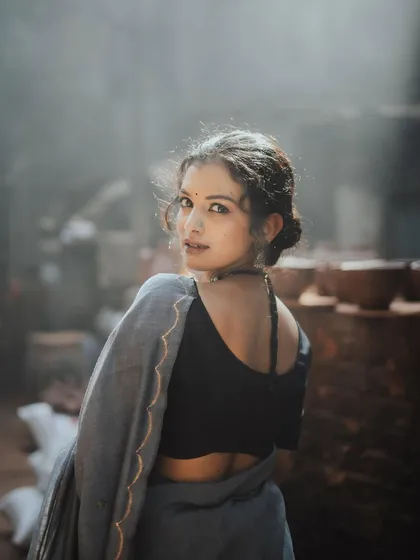 I love playing with light and shadow to create moody, evocative portraits. This shot, taken in a rustic setting, uses the soft, diffused light to highlight the model's expression as she looks back, creating a sense of story and intrigue.