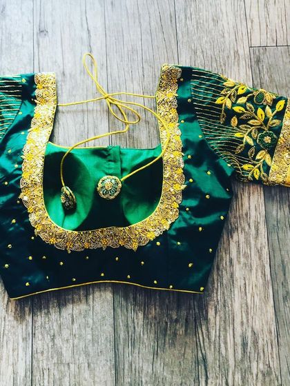 A bottle green silk blouse with gold embroidery. I used the saree's Zari border on the sleeves and added a simple embroidered border to the neckline.