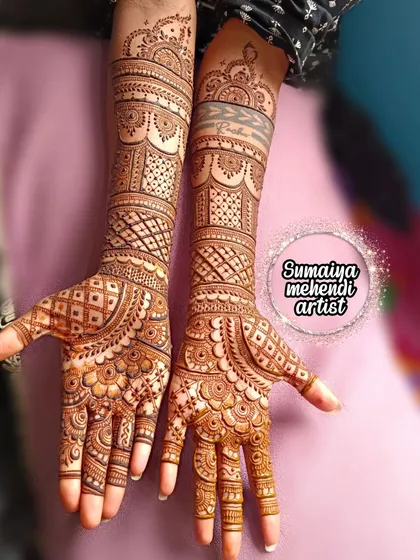 A stunning full-hand bridal mehendi that extends up the arm. The patterns are dense and traditional, perfect for a bride on her big day.