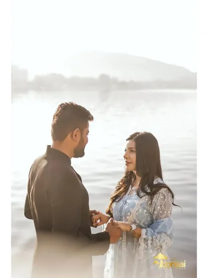 A tender moment by the water. The soft light and natural setting provide a serene backdrop for this romantic couple portrait.