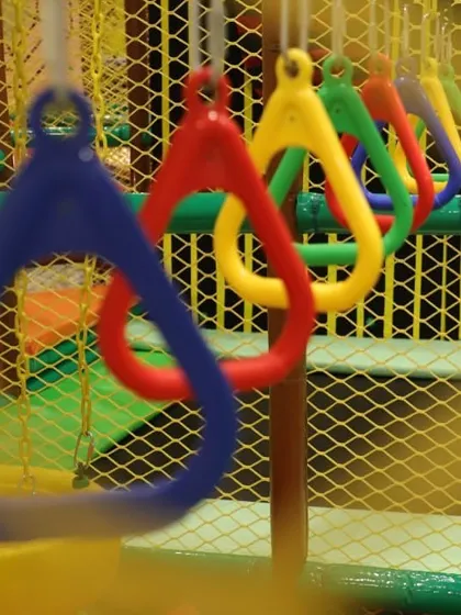 A close-up of the colorful hanging rings in our ninja course, designed for swinging and testing upper body strength in a fun way.