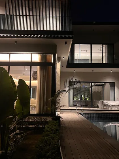 'The One' residence at night, where strategic lighting highlights the layered levels of the facade. The interplay of light and shadow reveals the nuanced interaction between the different architectural elements.