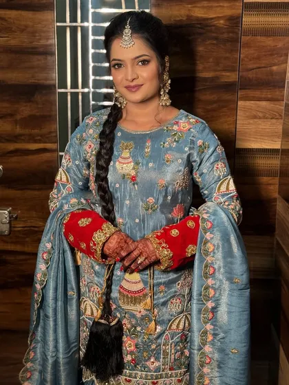 A portrait of the client, her hair in a long, traditional braid.