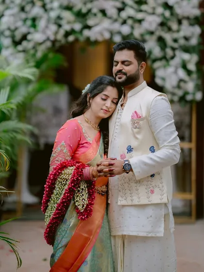 A serene and heartfelt moment. Gayatri rests her head on Saurabh's shoulder, her floral garland adding a touch of traditional beauty to this engagement portrait.