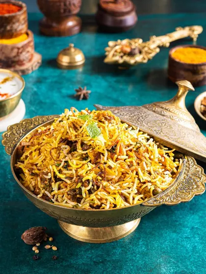 A majestic bowl of biryani, styled in traditional brassware. I used spices and herbs as props to tell the story of the dish's rich flavours and aromatic ingredients.