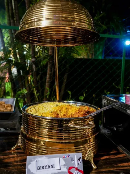 Our signature Biryani, served in a traditional brass pot. This is a cornerstone of our menu, loved for its rich flavor and fragrant aroma.