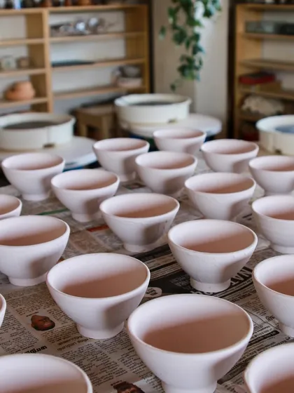 Rows of bowls drying before being bisque fired. This was part of a large order, and seeing them all lined up is a satisfying part of the production process.