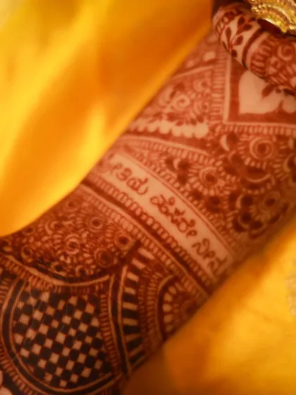 A close-up of the Kannada script on the arm, showing the beautiful stain color.